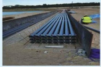 Stacked cable ducts in a prepared trench at Pulau Tekong.