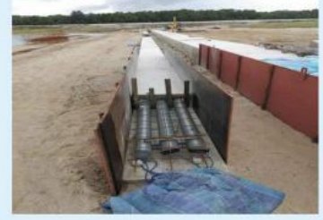 Open utility trench prepared for cable installation.