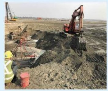 Excavator forming the polder roadbed at Matarbari.