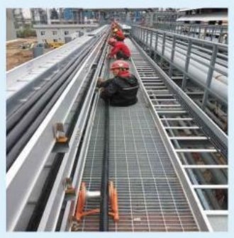 Elevated cable tray installation at Tuas Power Generation.